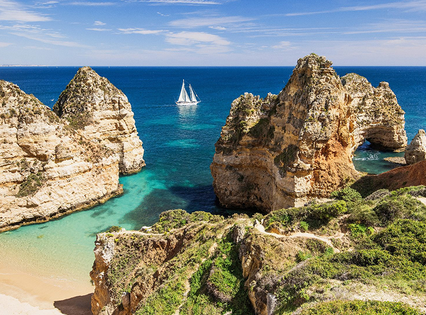Stunning Algarve cliffs with sailboat